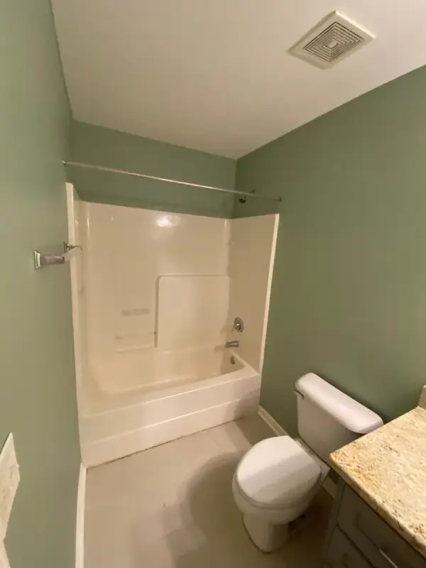 Sage green bathroom with white tub surround and ceiling, Bellevue, TN