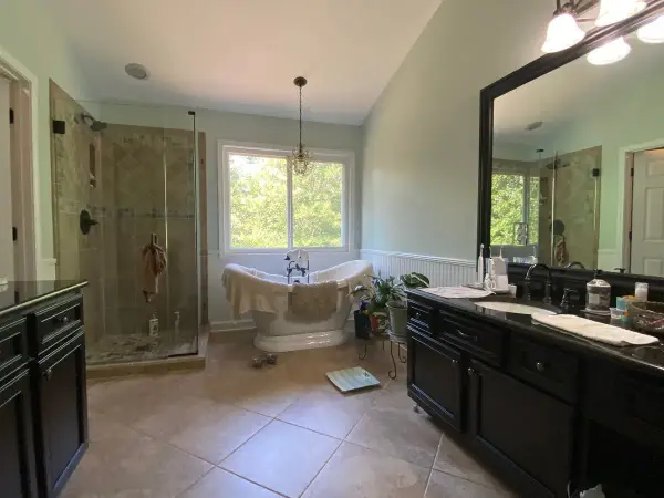 Primary bath with pale blue-green walls and white beadboard, Bellevue, TN