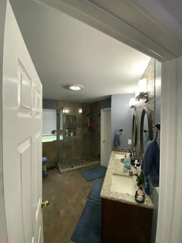 Primary bath with pale walls and white door, Brentwood, TN