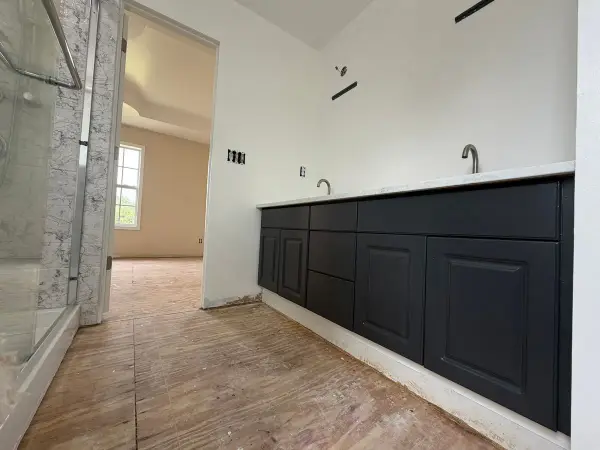 Long dark charcoal vanity beside a glass shower, Pleasant View, TN