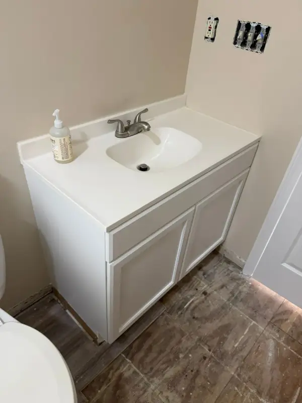 White bathroom vanity against cream walls and bare subfloor, Pleasant View, TN