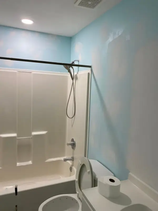 Bathroom with patched blue walls beside a tub, Pleasant View, TN
