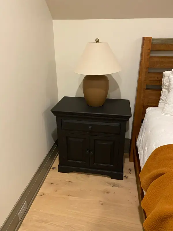 Black nightstand beside a bed, dark greige baseboard, Belle Meade, TN