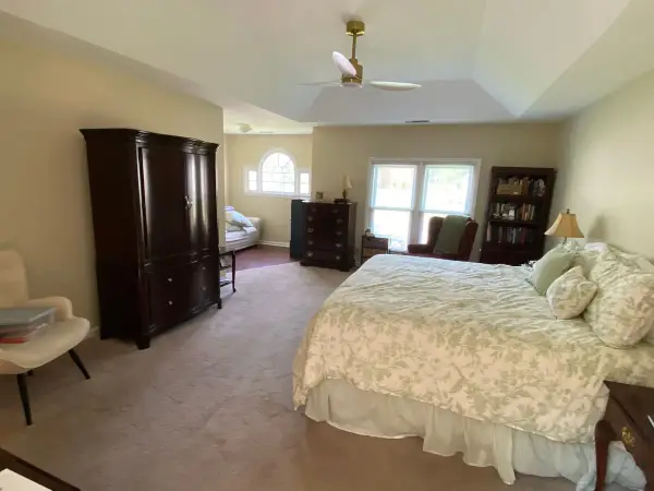 Bedroom with warm neutral walls, tray ceiling and arched window, Bellevue, TN