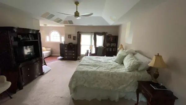 Wide bedroom view with tray ceiling and arched window, Bellevue, TN