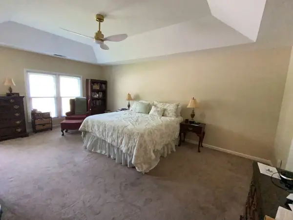Bedroom with neutral walls and white tray ceiling, side view, Bellevue, TN