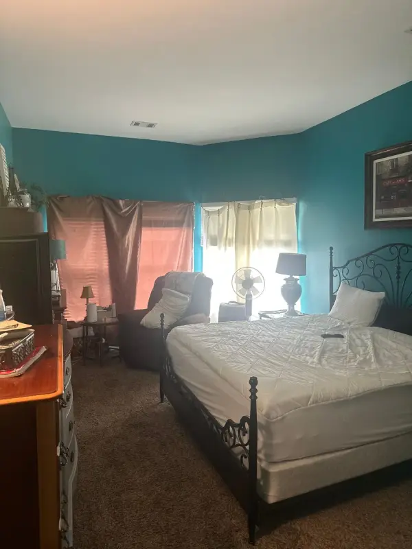 Teal bedroom with white trim and curtained windows, Brentwood, TN