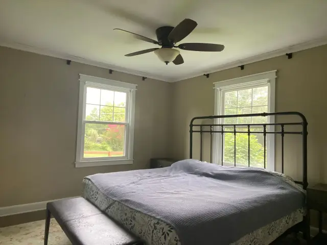 Tan bedroom with white crown, window trim and ceiling fan, Fairview, TN
