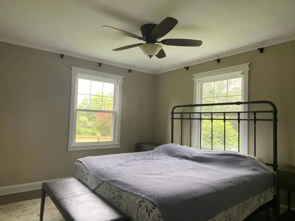 Tan bedroom with white crown, window trim and ceiling fan, Fairview, TN