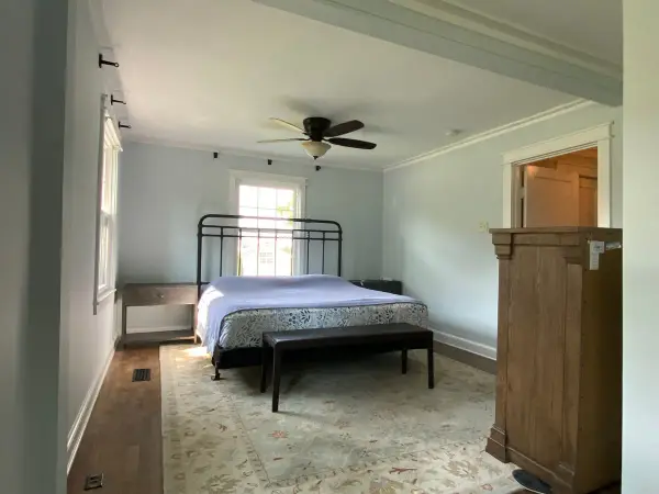 Pale blue-gray bedroom with white trim and iron bed, Fairview, TN