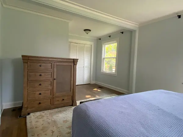 Pale blue-gray bedroom with white bifold closet doors, Fairview, TN