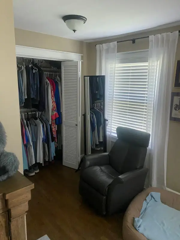Closet with white louvered doors beside a window, Fairview, TN