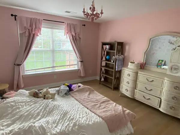 Pink bedroom with white trim and curtained window, Franklin, TN