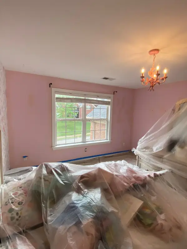 Pink bedroom with furniture gathered under plastic, Franklin, TN