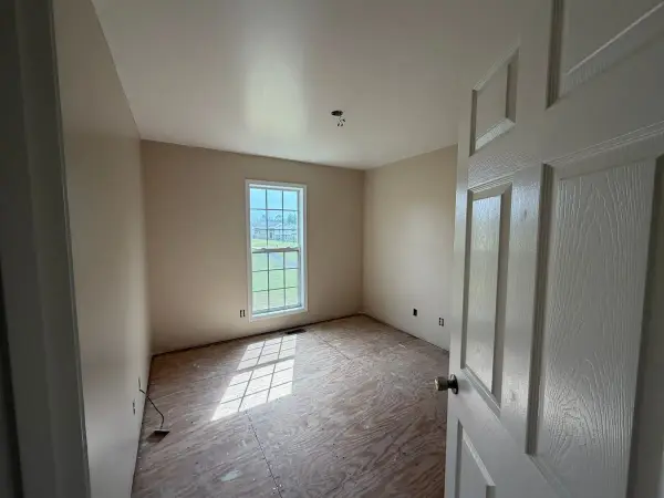 Cream bedroom with white door and single window, Pleasant View, TN