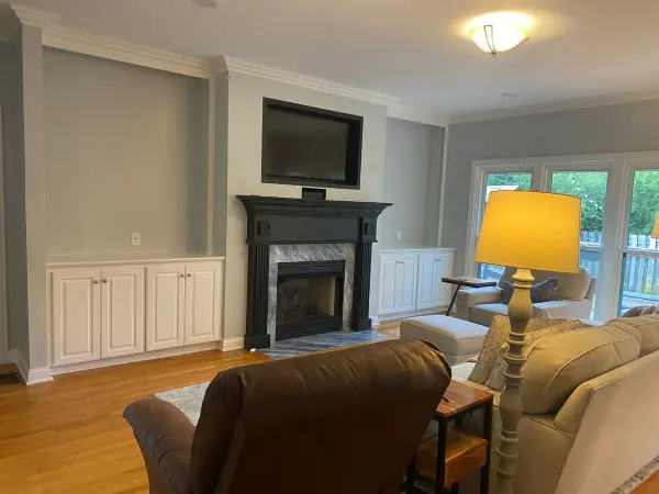 White built-in cabinets beside a black fireplace mantel, Franklin, TN