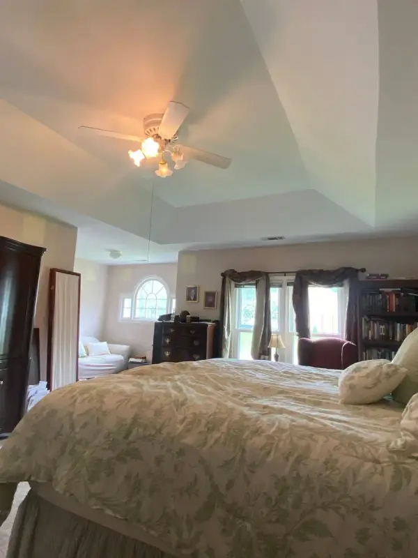 Tray ceiling with fan above a bed and arched window, Bellevue, TN