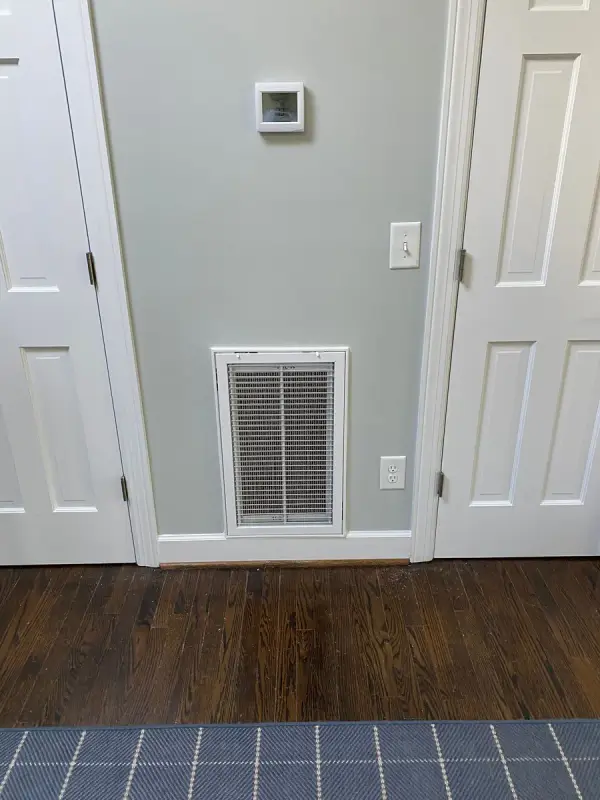 Hallway with pale gray-green walls between two white doors, Belle Meade, TN
