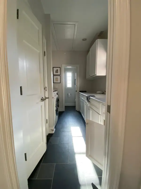 White door opening onto a narrow laundry hall with slate floor, Belle Meade, TN