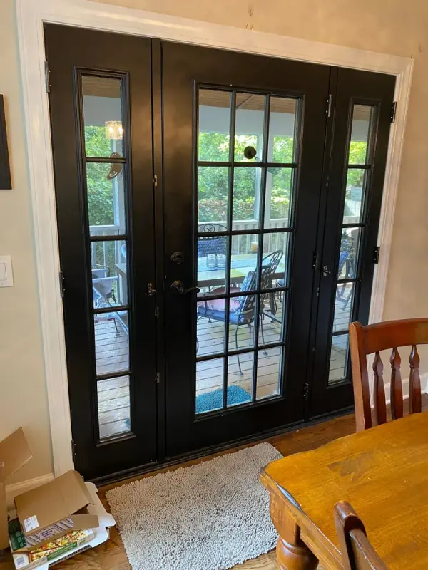 Black French doors seen past a dining table, Bellevue, TN