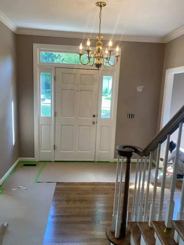 White front door with sidelights and transom under a chandelier, Bellevue, TN