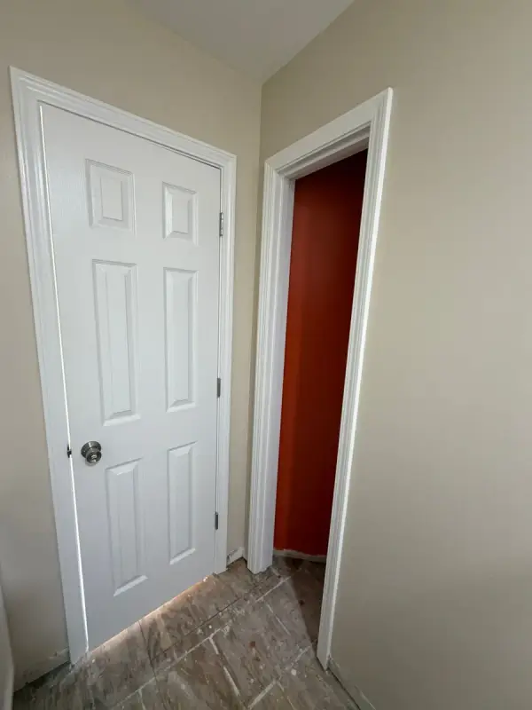 White six-panel door beside a burnt orange wall, Pleasant View, TN