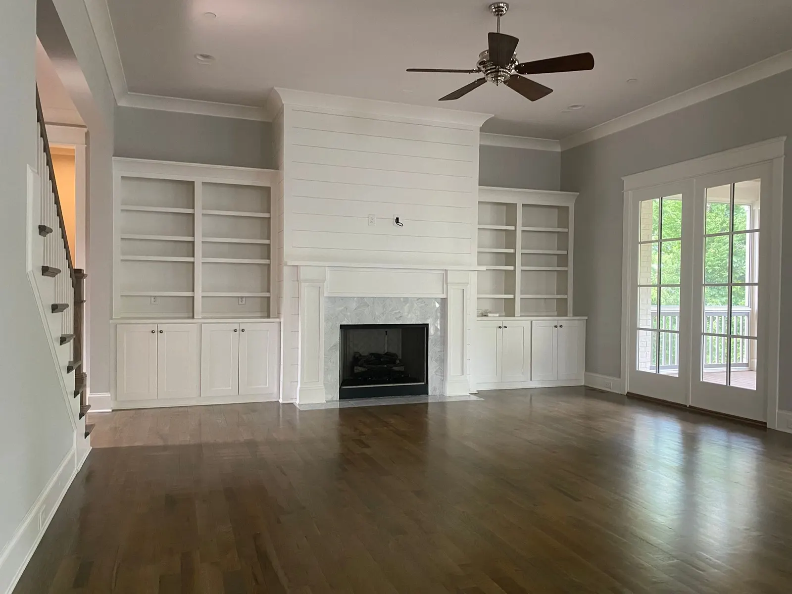 White shiplap fireplace wall and built-ins in an empty family room, Belle Meade, TN