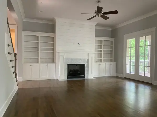 White shiplap fireplace wall and built-ins in an empty family room, Belle Meade, TN