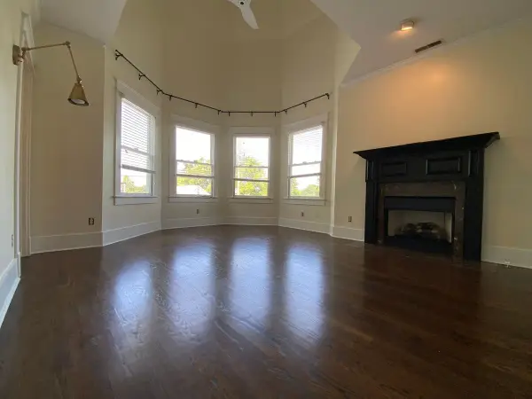 Empty room with black fireplace mantel and window bay, Brentwood, TN