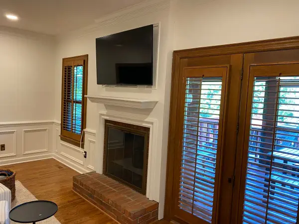 White mantel and wainscoting next to stained French doors, Brentwood, TN