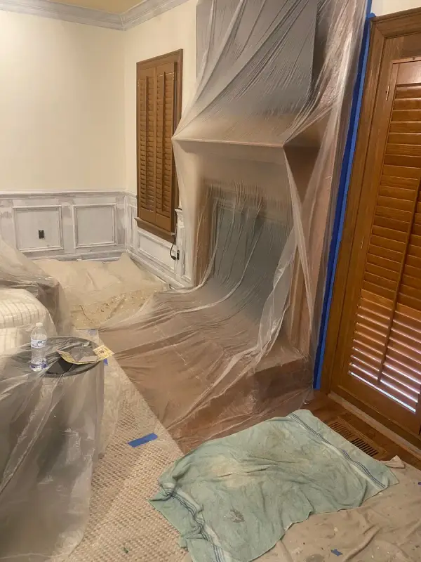 Fireplace wall sealed in plastic sheeting for spraying, Brentwood, TN