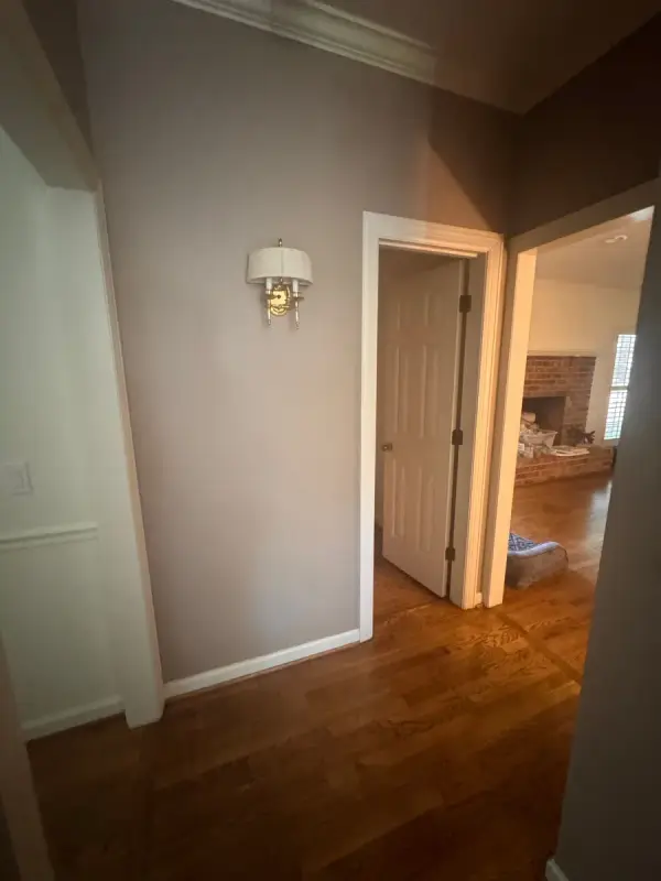 Taupe hall with a wall sconce and white door trim, Bellevue, TN