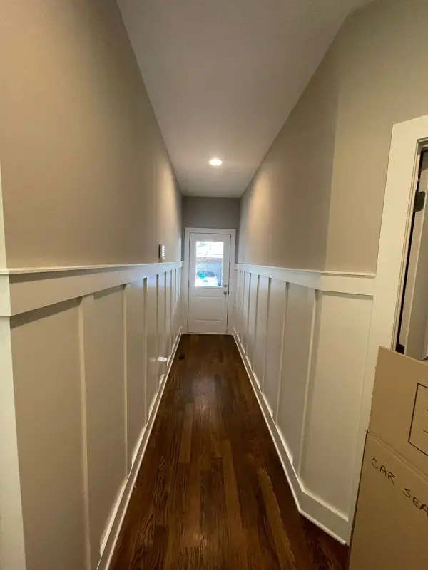 Narrow hall with tall white board-and-batten on both sides, The Nations, Nashville, TN