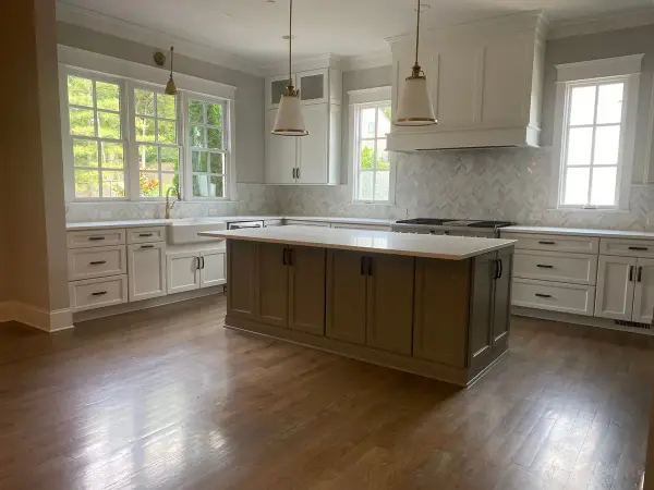 Empty kitchen with white cabinets, dark island and gray walls, Belle Meade, TN