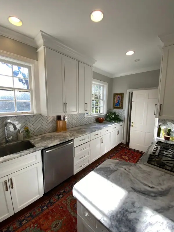 White kitchen cabinets with herringbone tile and a window, Belle Meade, TN
