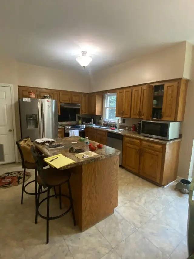 Oak-cabinet kitchen with beige walls and island, Bellevue, TN