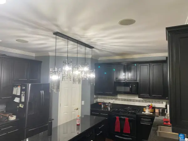 Black kitchen cabinets with gray walls and pendants, Bellevue, TN