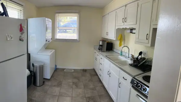 Galley kitchen with white cabinets and pale yellow walls, Brentwood, TN