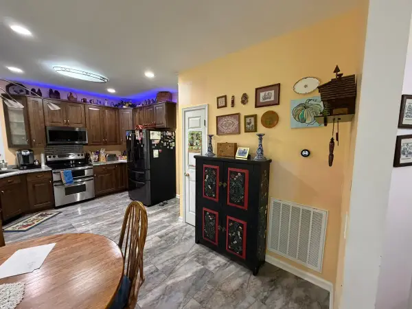 Butter-yellow wall beside a kitchen with wood cabinets, Brentwood, TN