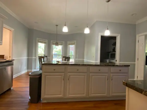 White kitchen island under pendant lights with gray walls, Franklin, TN