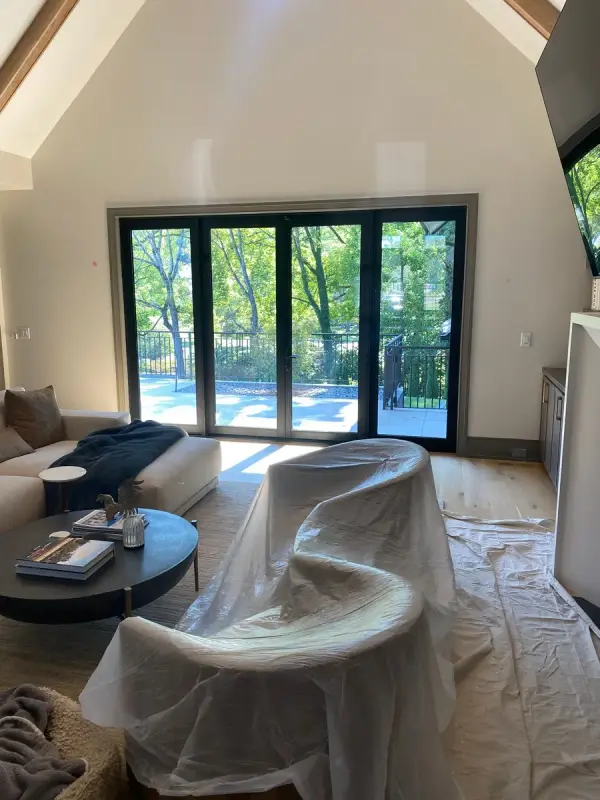 Vaulted living room with furniture under plastic, Belle Meade, TN