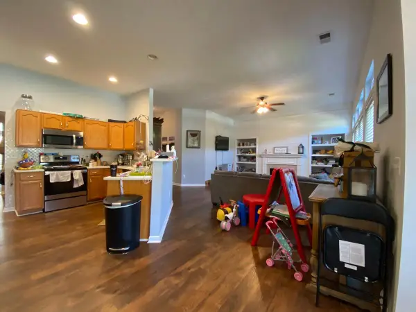 Open kitchen and family room with tan walls, Bellevue, TN