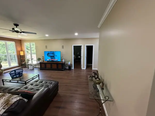 Long tan living room with white doors and ceiling fan, Bellevue, TN