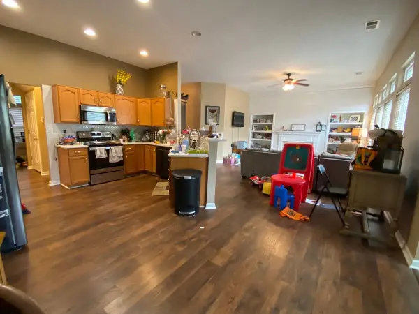 Open kitchen and living area with tan walls, wide view, Bellevue, TN