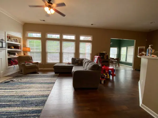Family room with tan walls, built-in shelves and windows, Bellevue, TN