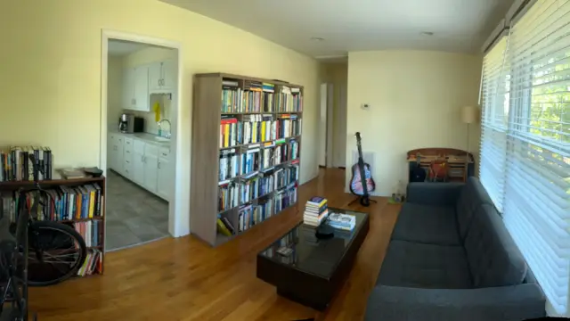 Panorama of a living room with pale yellow walls and white door, Brentwood, TN