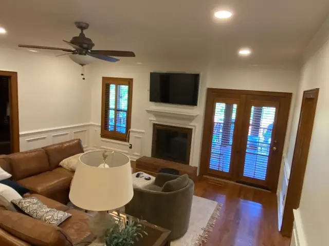 Finished family room with white fireplace surround and wainscoting, Brentwood, TN