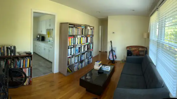 Panorama of a living room with pale yellow walls and white door, Brentwood, TN