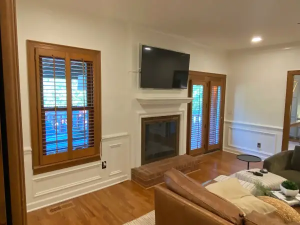 Family room with white walls, wainscoting and a painted fireplace surround, Brentwood, TN