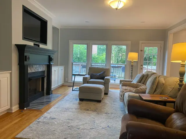 Family room with light gray walls and a black fireplace mantel, Franklin, TN